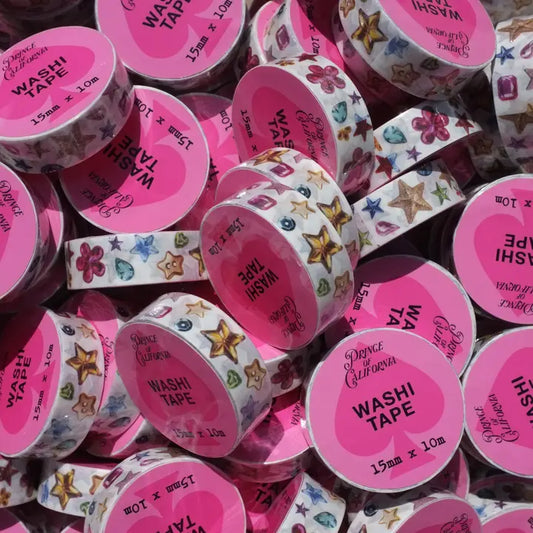 Assorted washi tape rolls with colorful designs and pink labels.