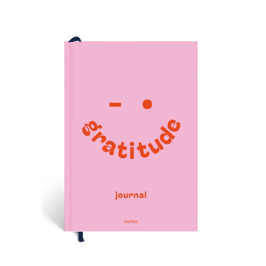 Pink journal with 'gratitude' text on a white background