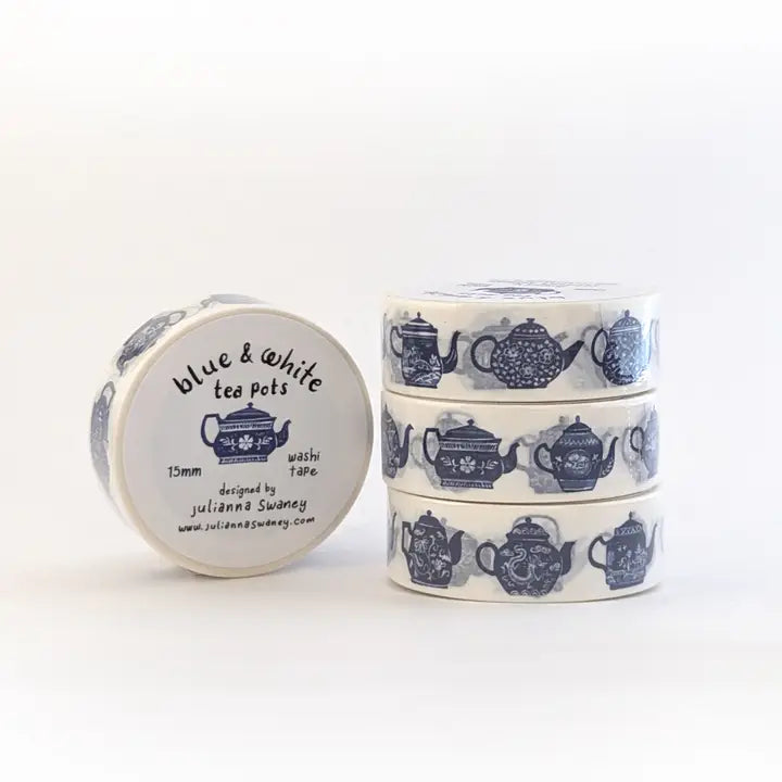 Roll of blue and white washi tape with teapot design on a white background