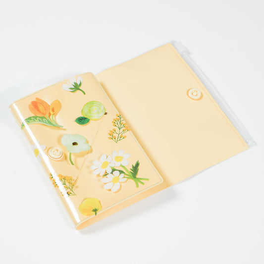 Open notebook with floral stickers on a white background