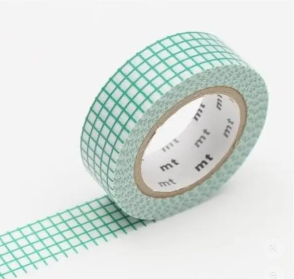 Green grid-patterned tape with 'mt' branding on a white background