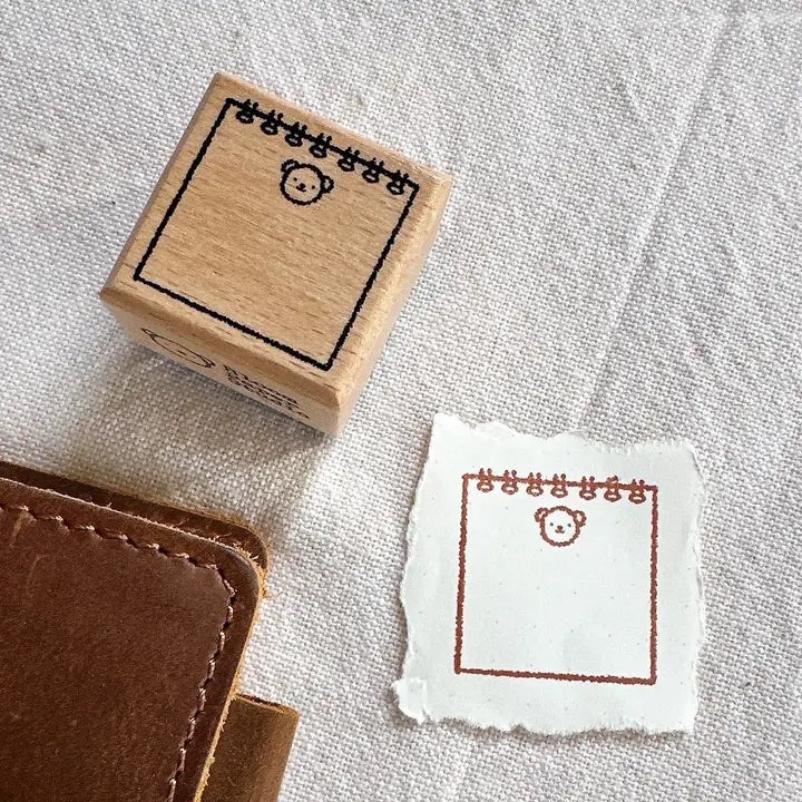 Wooden stamp with a design on a white fabric background
