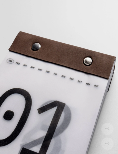 Calendar with a brown leather strap on a white background