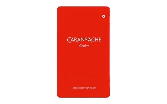 Red notebook with 'Caran d'Ache Geneve' branding on a white background