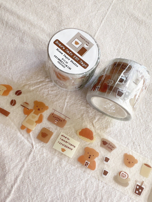 Clear washi tape with cute designs on a textured surface