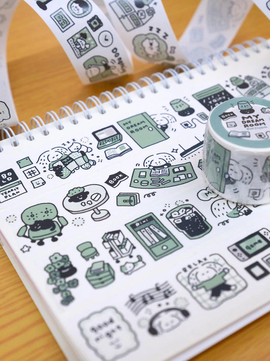 Notebook with cute illustrations of rooms and a roll of decorative tape on a wooden surface