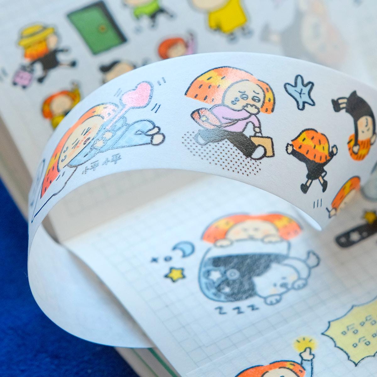 Roll of paper with cartoon character designs on a blurred background