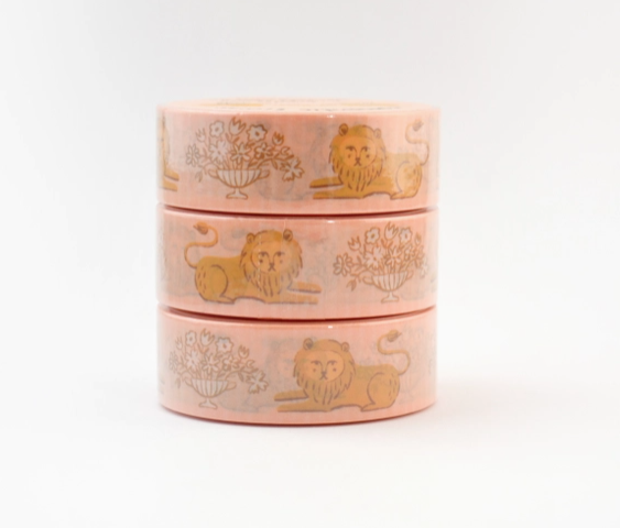 Three rolls of pink washi tape with lion designs on a white background