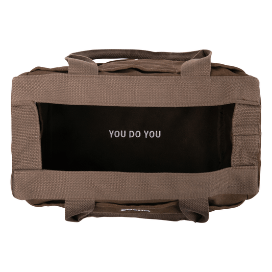 Brown bag with a black interior and 'YOU DO YOU' text on a white background
