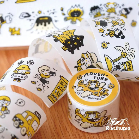 Decorative tape with cartoon designs and 'Adventure' label on a wooden surface, featuring the Rin Studio logo.