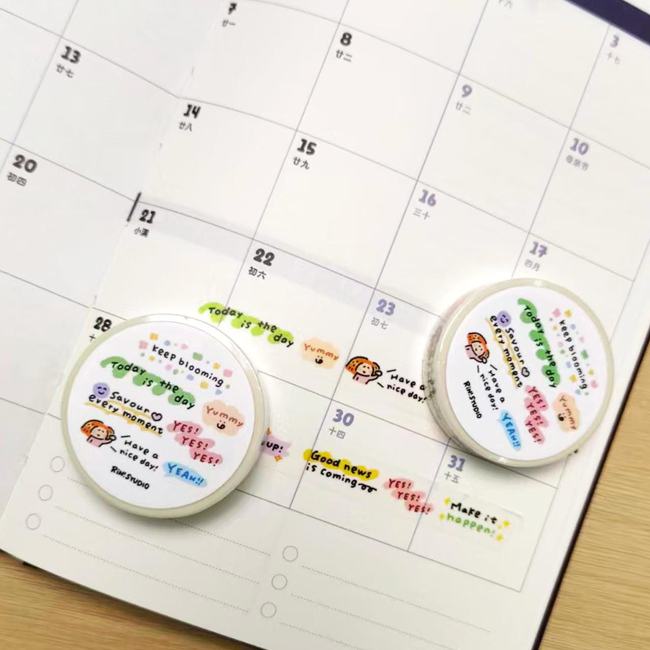 Two circular planners with colorful text and illustrations on a calendar page.