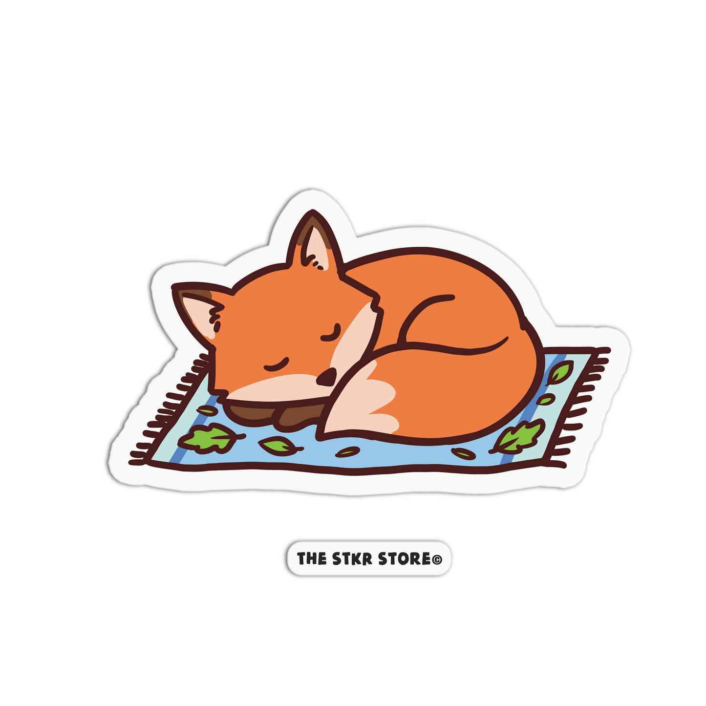 Sticker of a sleeping fox on a rug with 'The Stkr Store' logo.