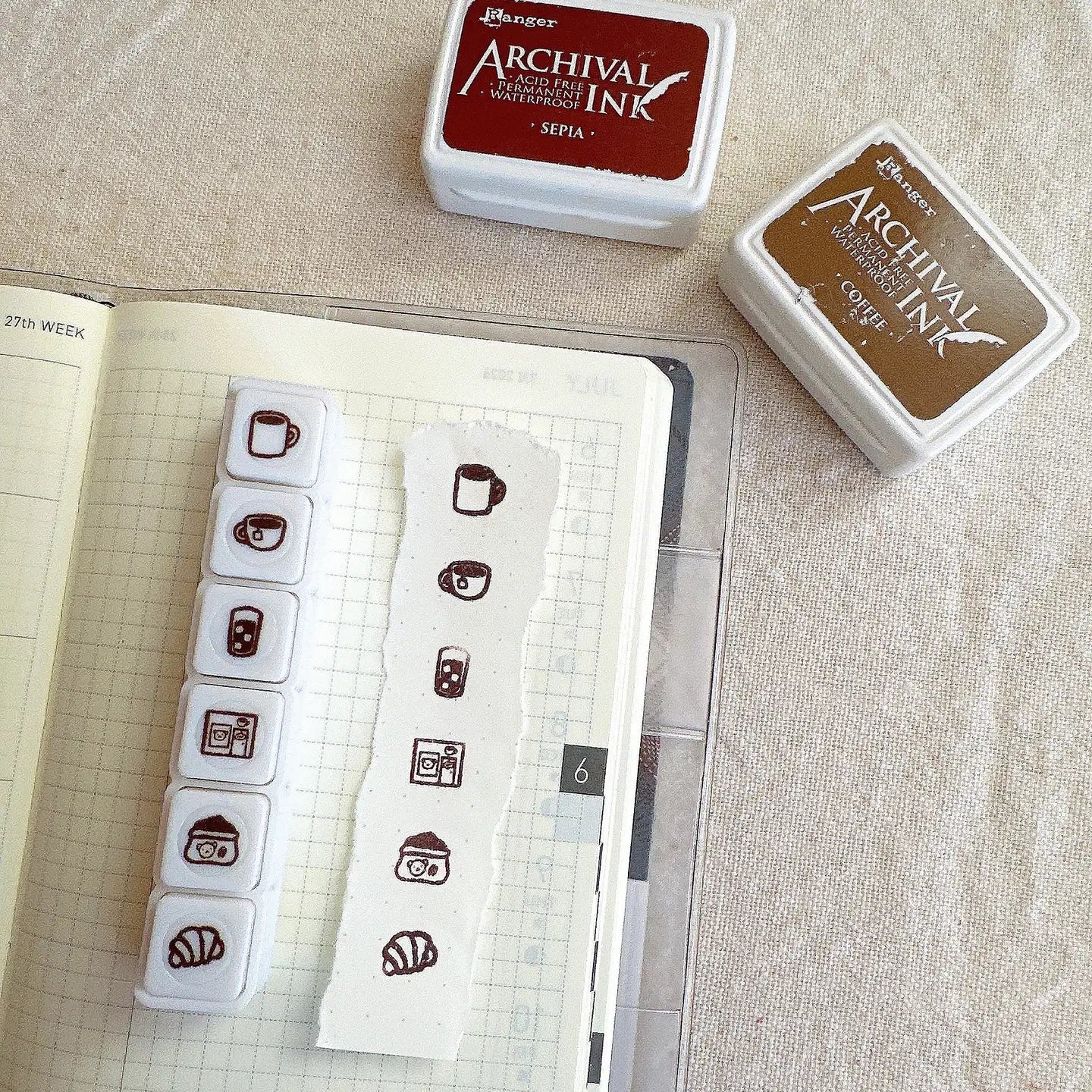 Archival ink pads and stamps on a notebook with grid paper