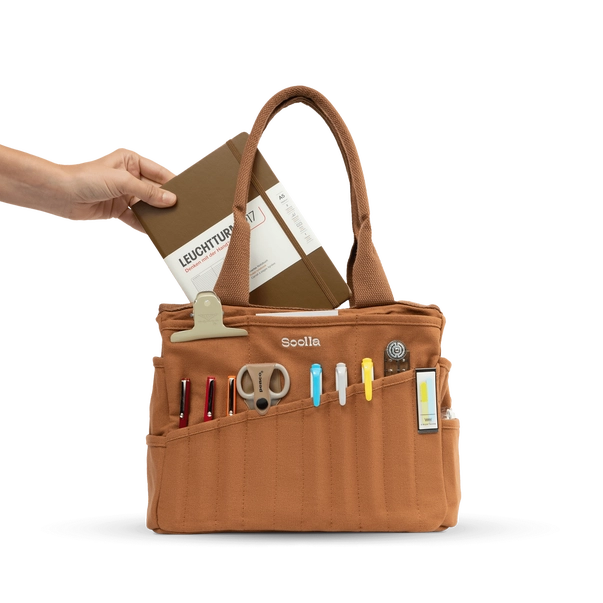 Brown tool bag with various compartments and tools on a white background