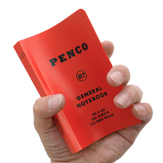 Red notebook with 'Penco' branding held in a hand against a white background