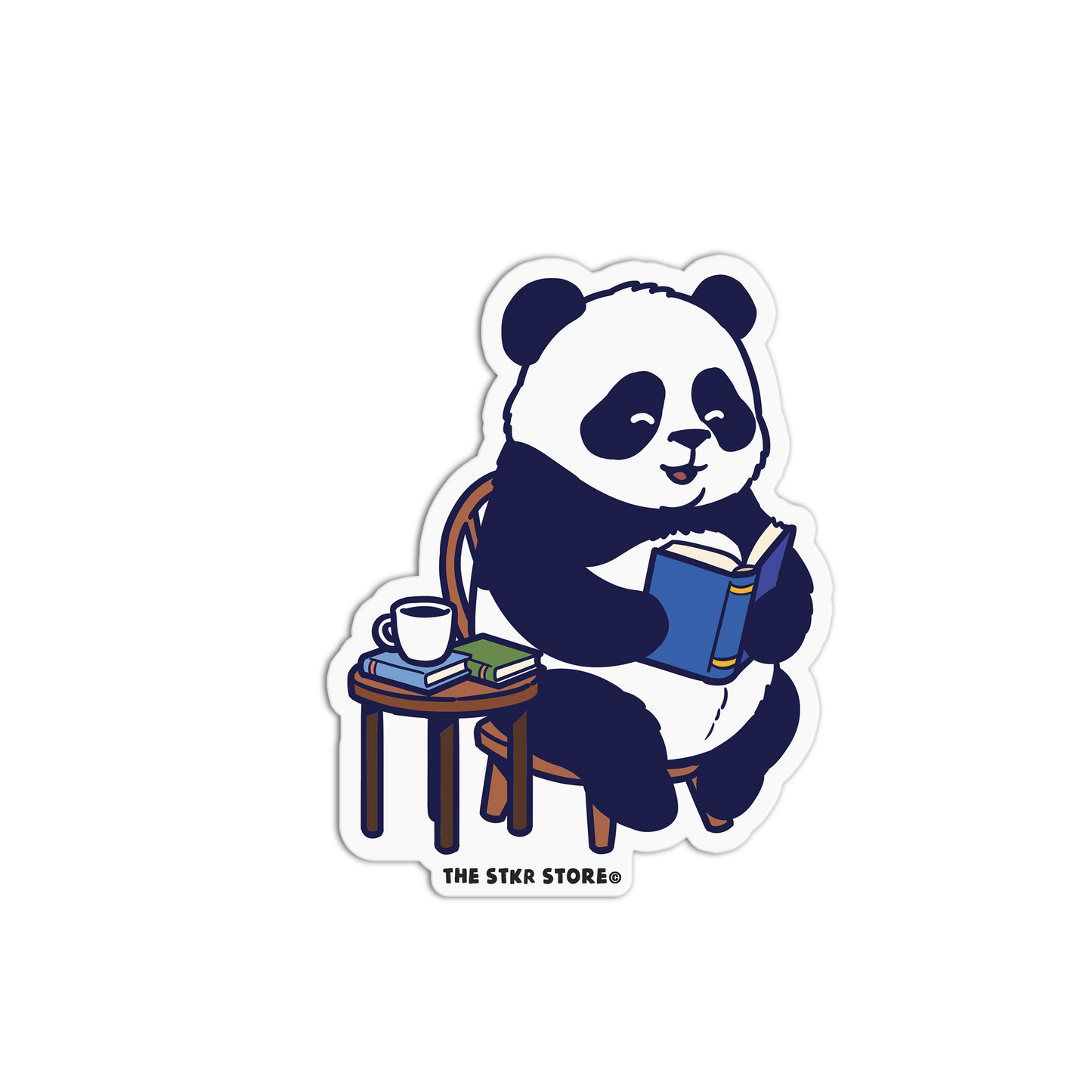 Sticker of a panda reading a book with a cup and books on a table, branded 'The Stkr Store'.