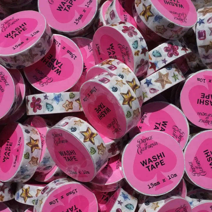 Assorted washi tape rolls with colorful designs and pink labels.