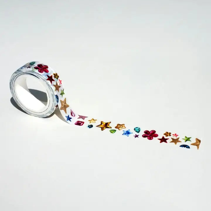 Roll of decorative tape with colorful star and flower designs on a white background