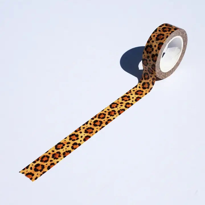 Roll of leopard print tape on a light blue background