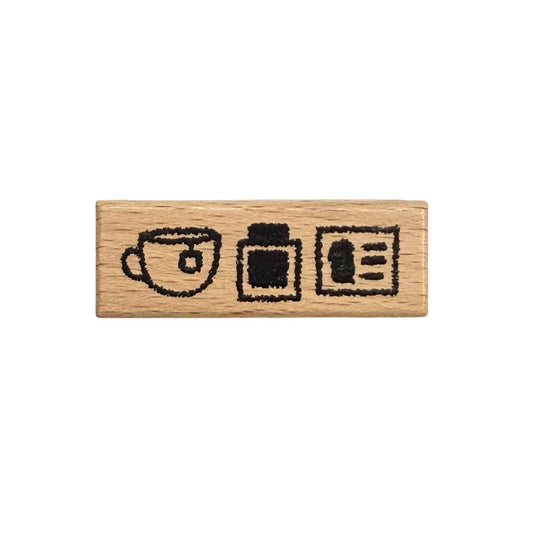 Wooden stamp with tea cup, ink pot, and ink card illustrations on a white background