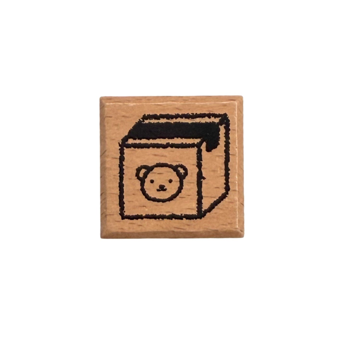 Wooden stamp with a bear design on a white background
