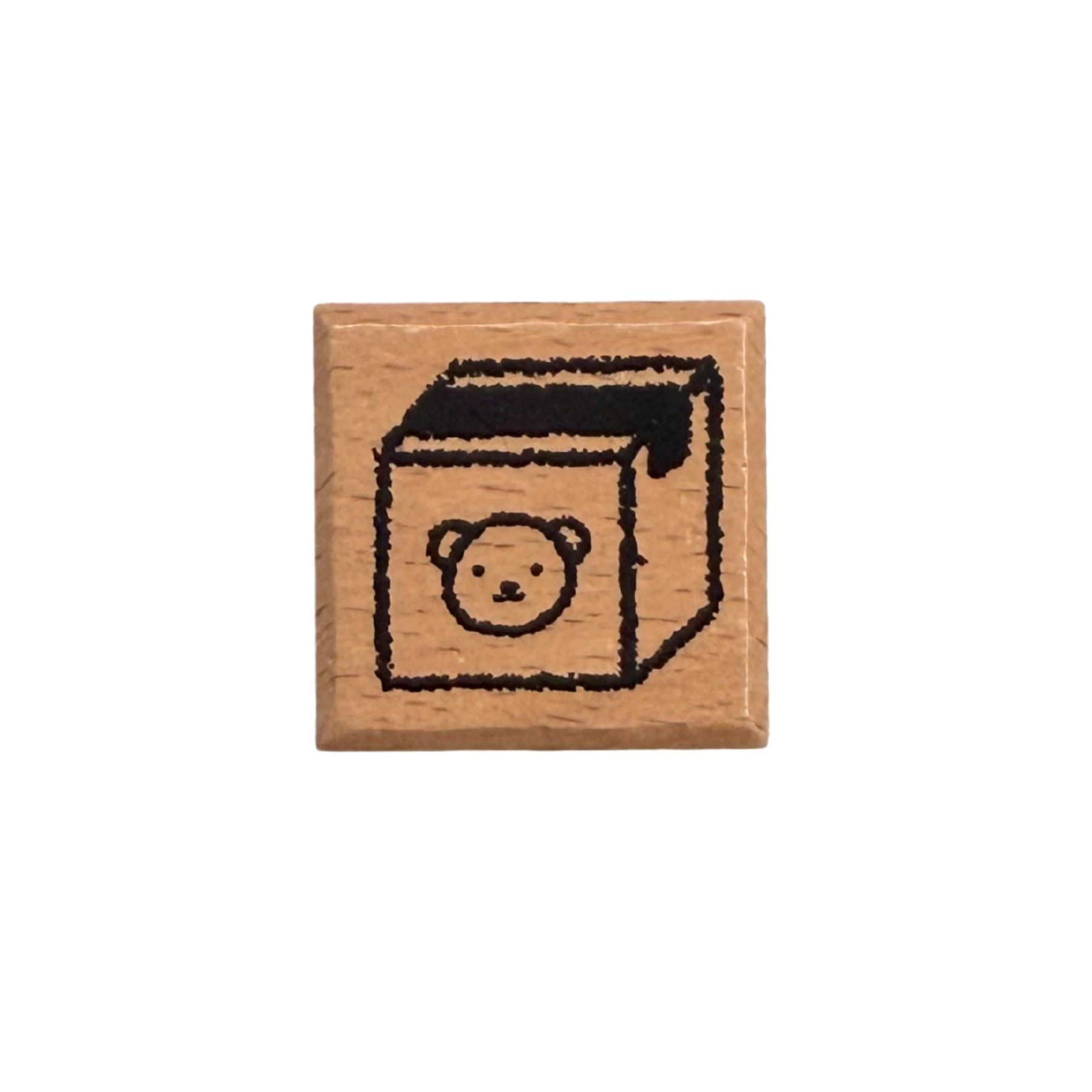 Wooden stamp with a bear design on a white background