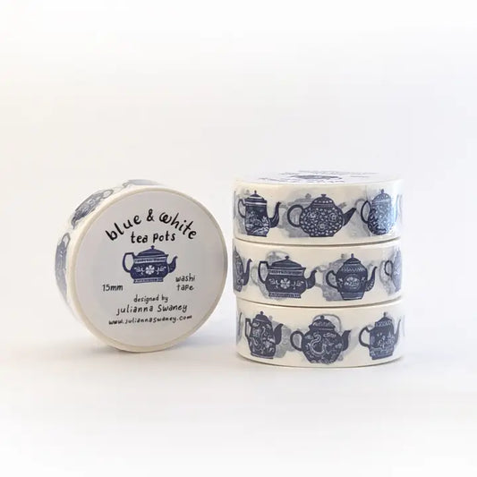 Roll of blue and white washi tape with teapot design on a white background