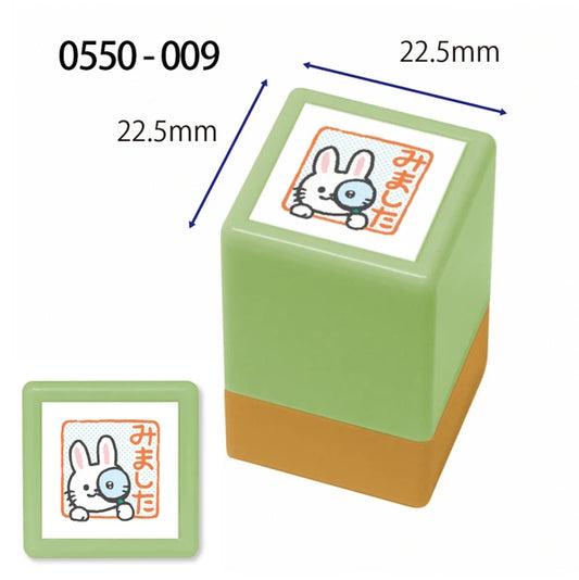 Green and brown rubber stamp with a cartoon rabbit design and measurements on a white background