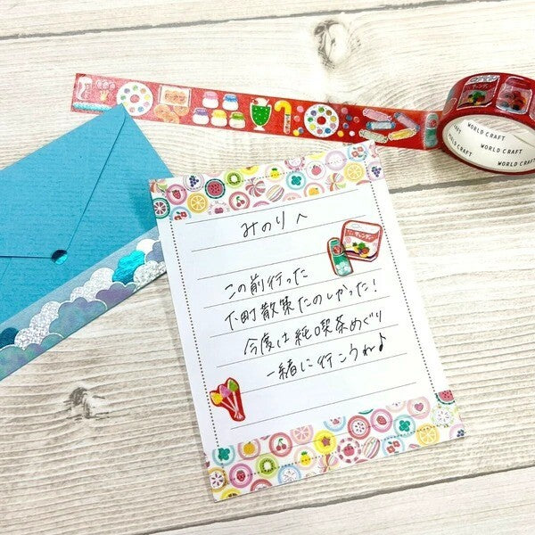 Colorful stationery set with a letter on a wooden surface