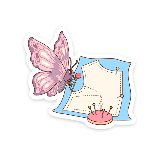 Sticker with a pink butterfly, sewing pattern, and pins on a white background