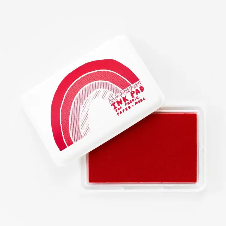 Red ink pad with a white handle on a white background