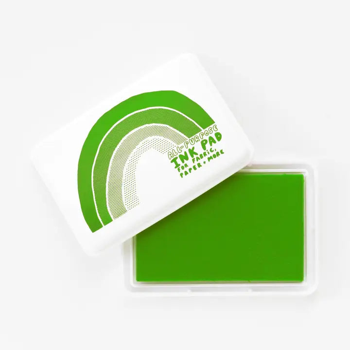 Green ink pad with a white handle on a white background