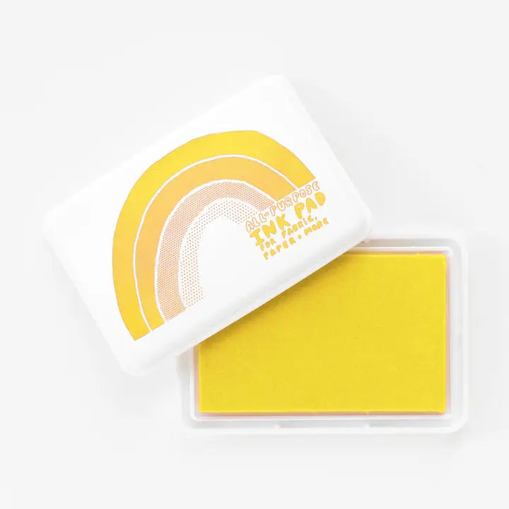 Yellow ink pad with a white handle on a white background