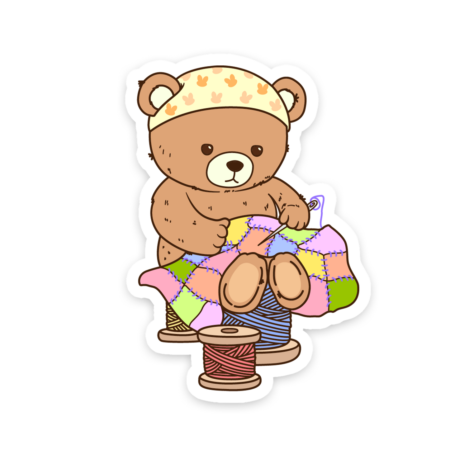Cartoon bear with yarn and a spool on a white background