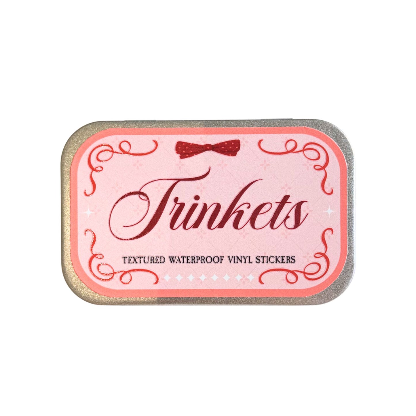 Pink tin labeled 'Trinkets' with decorative elements on a white background