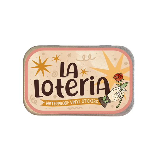 A rectangular tin of La Loteria Waterproof Vinyl Stickers, featuring a retro-style cream and pink label with brown lettering and an illustration of a hand holding a red rose.