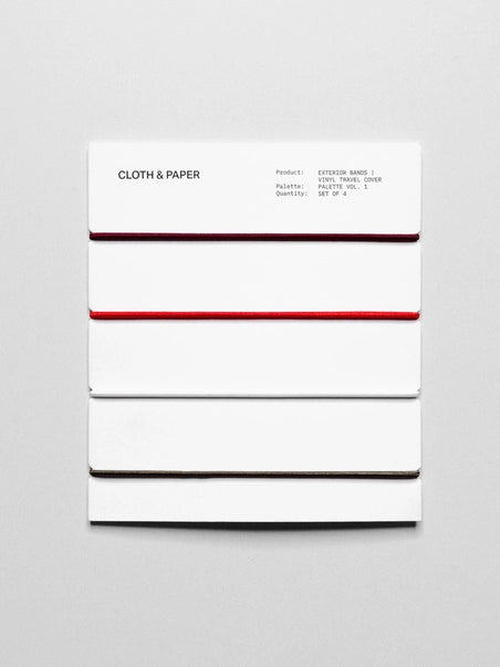 White exercise band with red stripe on a gray background