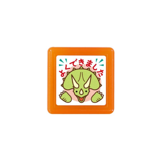 Small square toy with a green dinosaur design and orange border on a white background