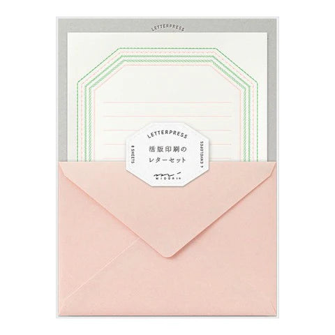 Letterpress stationery set with pink envelope and white card on a white background