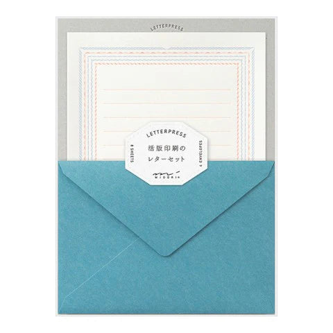 Set of letterpress stationery with envelopes and paper on a white background