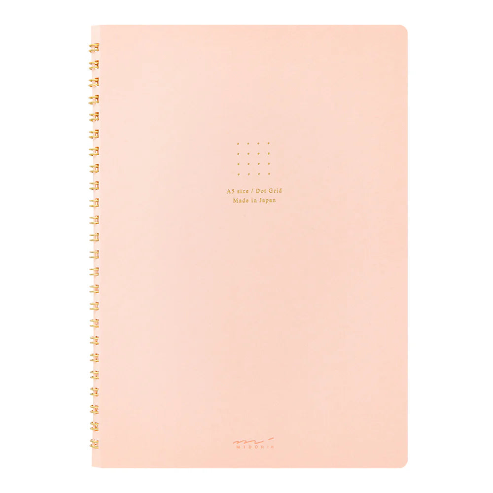 Pink notebook with gold text on a white background