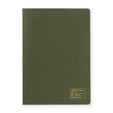 Green notebook with grid pattern on a white background