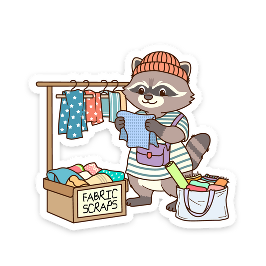 Cartoon raccoon character with fabric scraps and a clothesline on a white background