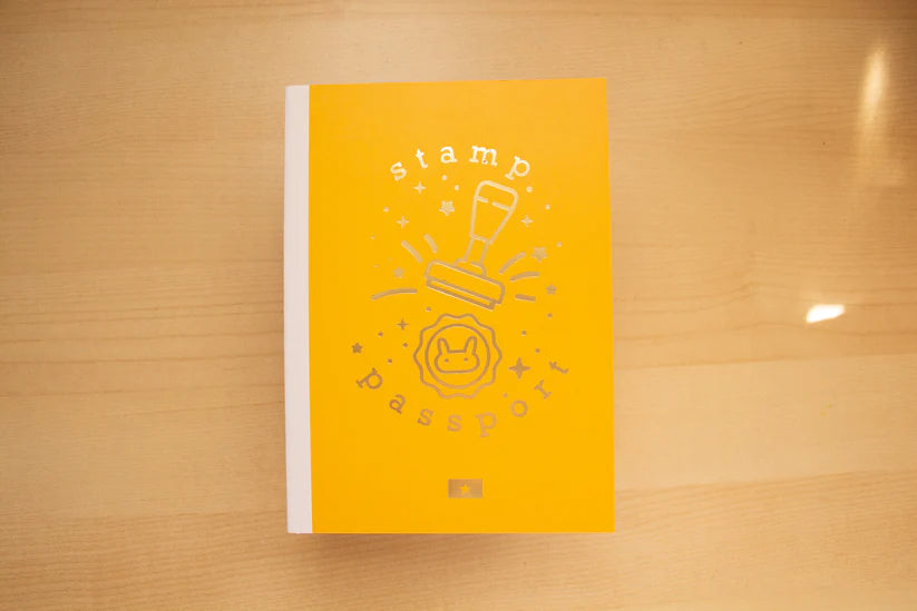Yellow book with white design on a wooden surface