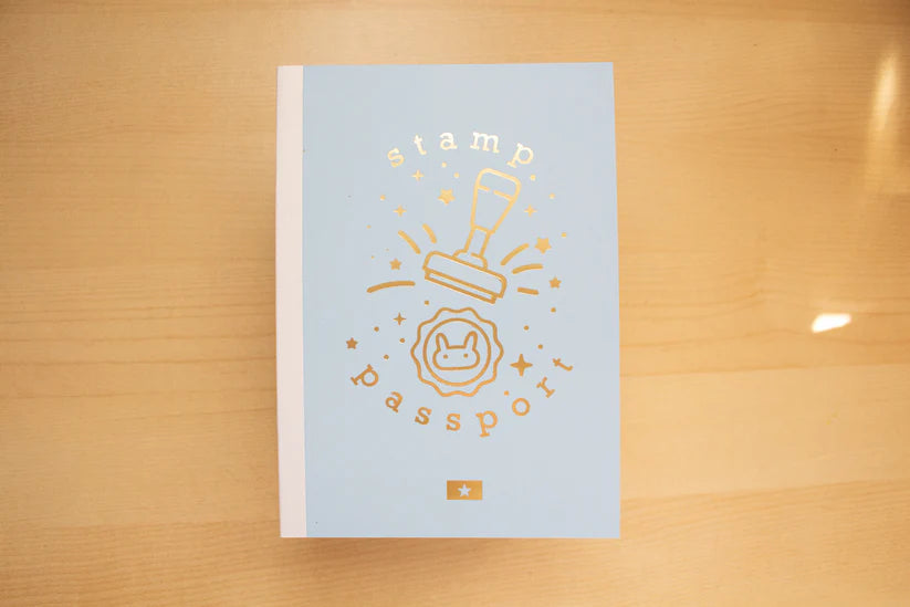 Light blue book with gold text and design on a wooden surface