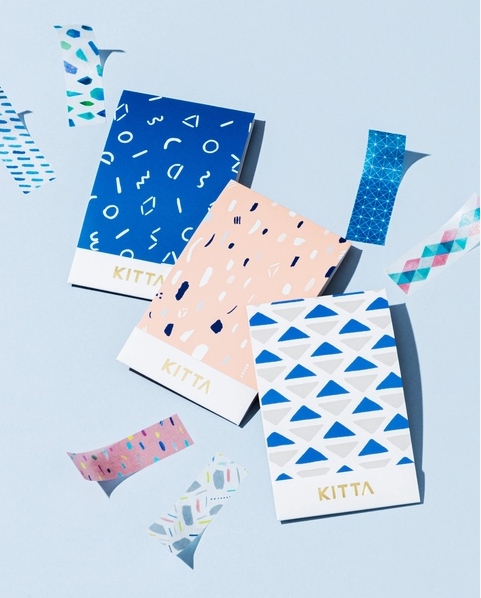 Three notebooks with geometric patterns and 'Kitta' branding on a light blue background