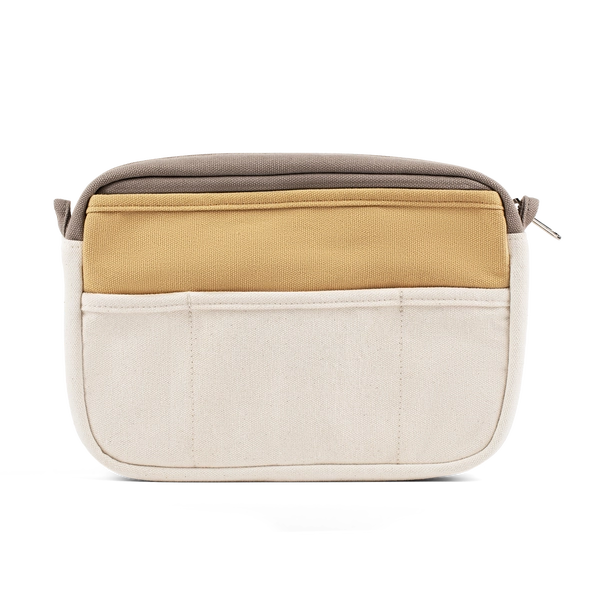 Multicolored bag with beige, brown, and white sections on a white background