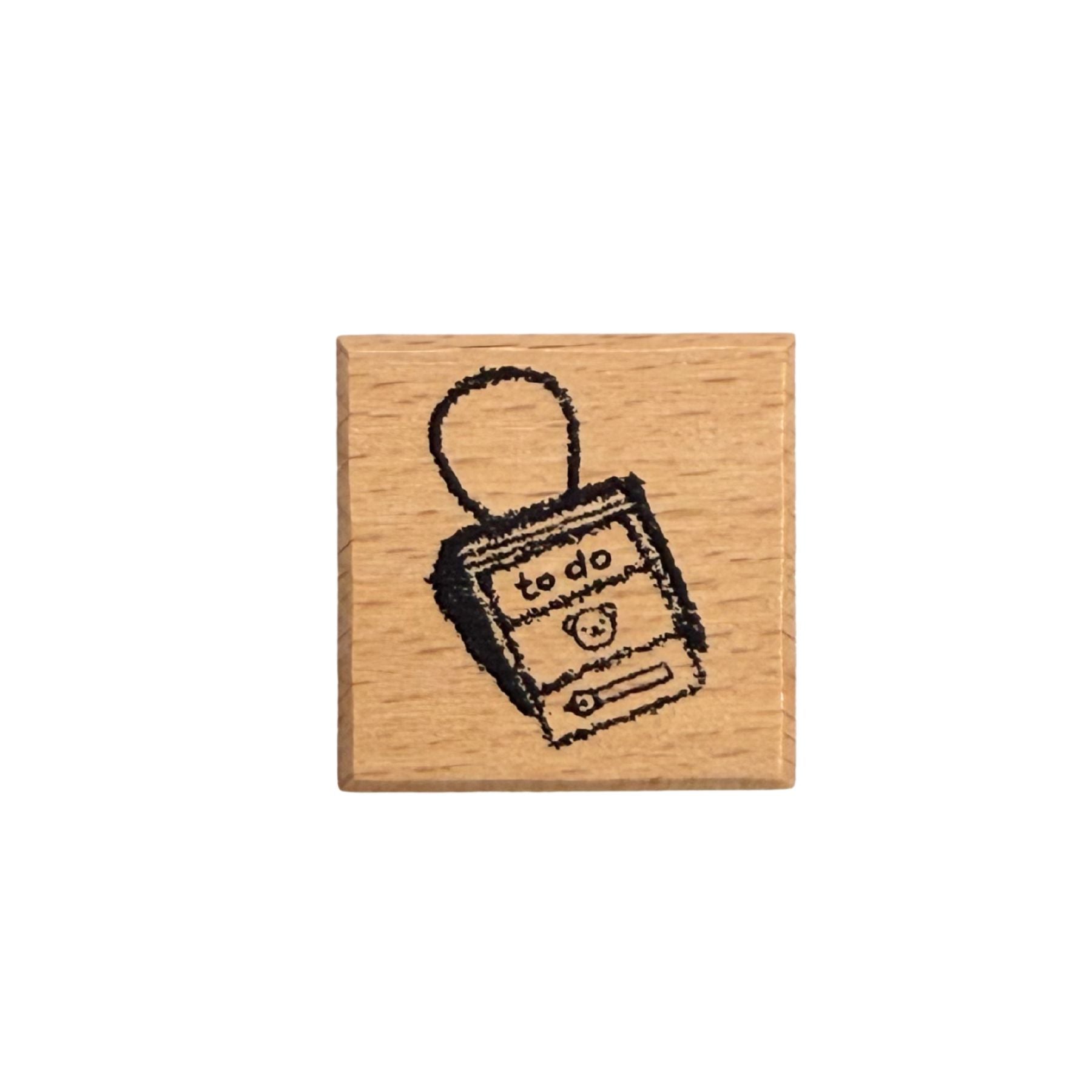Wooden stamp with a 'to do' list design on a white background