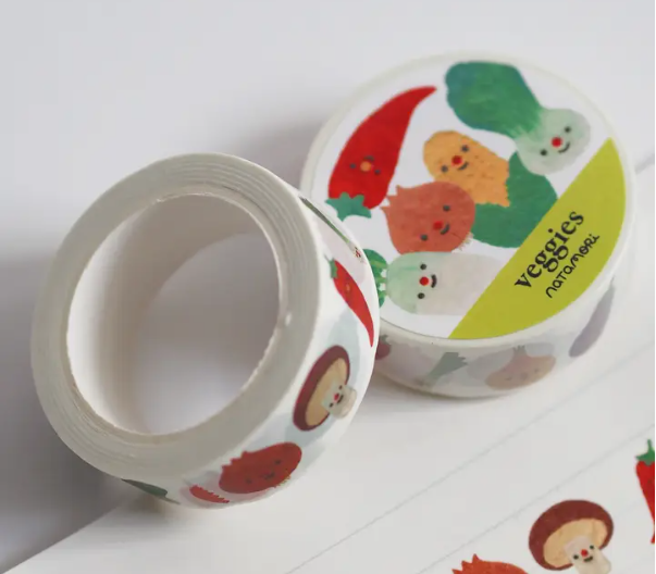 Roll of decorative tape with vegetable-themed design on a white background