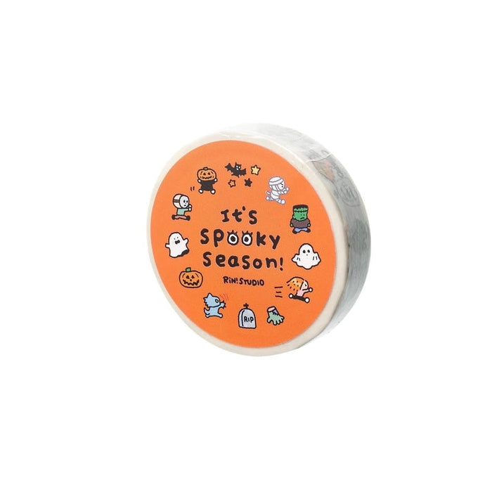 Round container with Halloween-themed design and text on an orange background